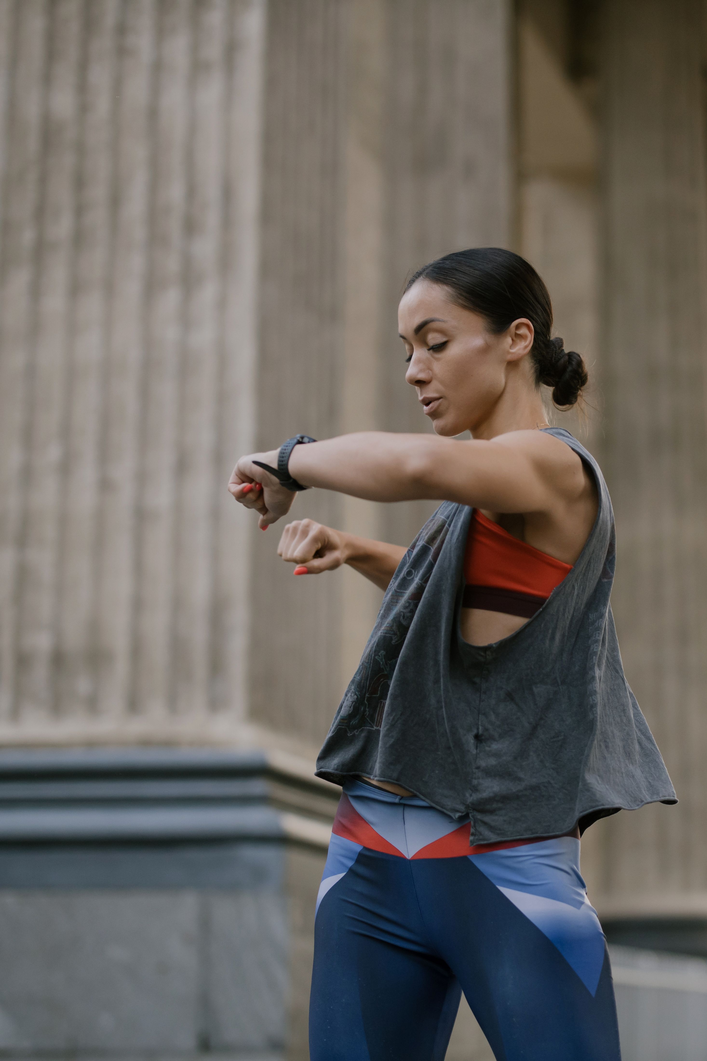 Woman checking her fitness tracker smartwatch during outdoor training