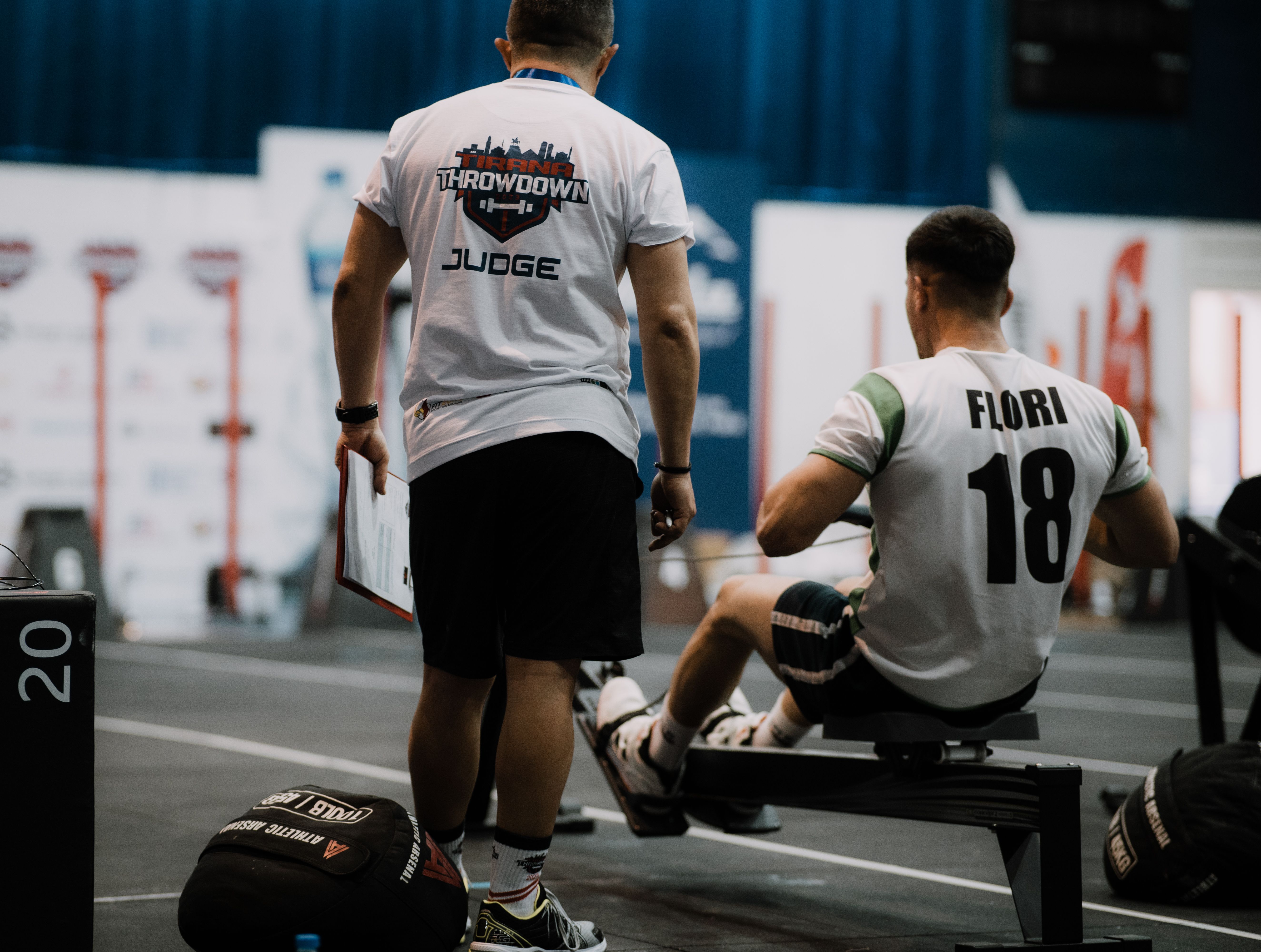 Judge overseeing a rowing competitor during a hybrid fitness race event