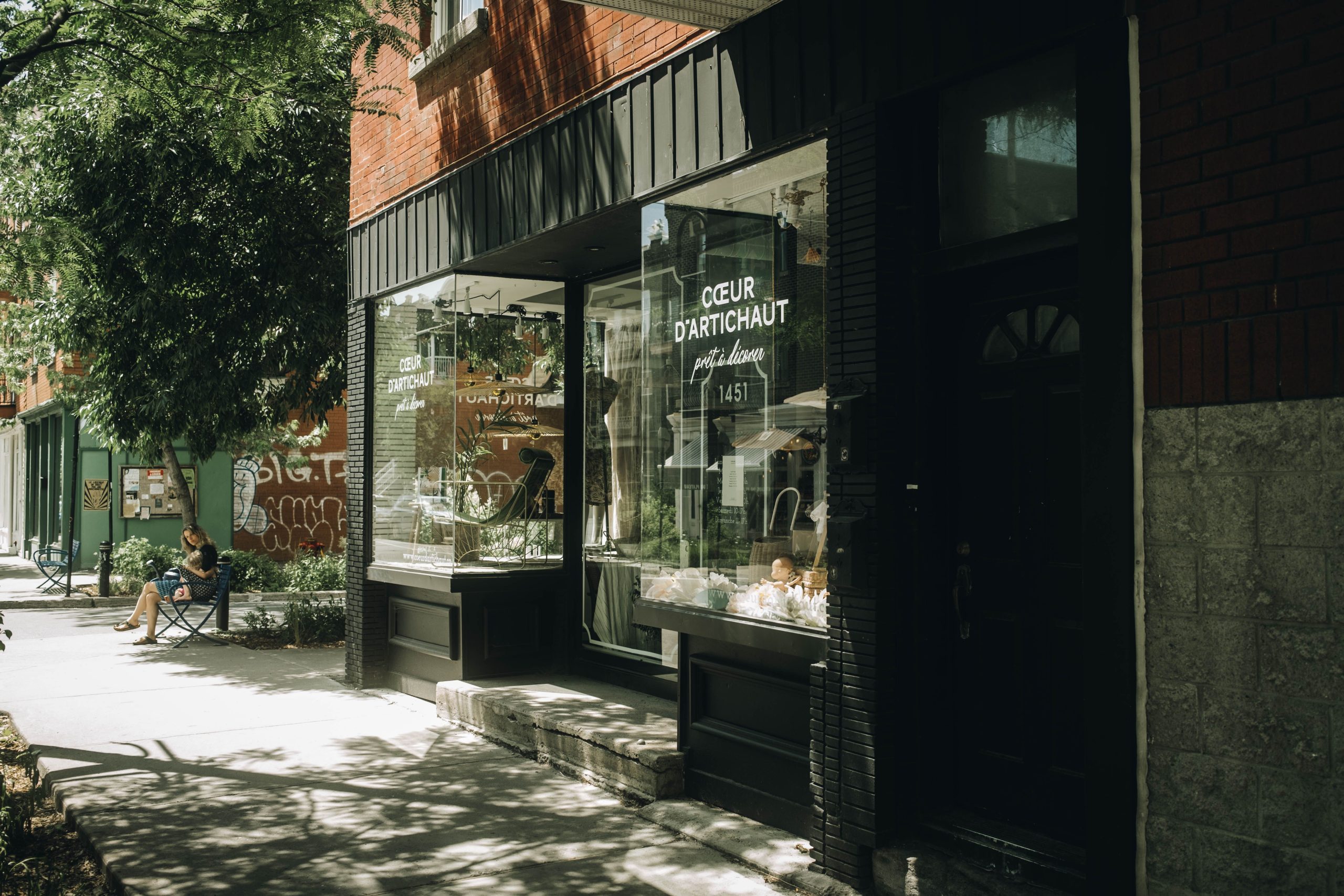 Quaint urban storefront with a large glass window on a sunny day